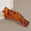 Macro detail of large leopard print hair claw clip with tortoise shell resin texture - Yellow Leopard