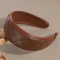 Detail of coffee brown leather headband featuring classic quilted diamond stitching texture - Brown
