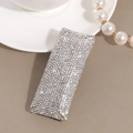 Close-up of elegant silver hair clip fully encrusted with sparkling clear rhinestones - White Rhinestone