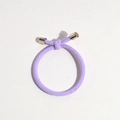Detail of light purple ribbed elastic hair tie featuring a knot and gold metal caps - Purple
