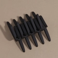 Macro detail of the black matte hair comb with cross teeth for securing hairstyles - Black