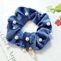Detail of navy blue velvet scrunchie with white pearls on a minimalist background - Lake Blue Pearl