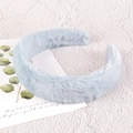 Close-up of soft light blue plush headband texture on decorative background - Blue Plush