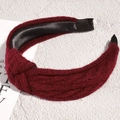 Detail of burgundy knitted knot headband with wool texture and black satin lining - Burgundy