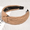 Macro view of brown cable-knit headband with twist knot design and soft satin lining - Khaki