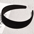 Close-up of a wide black velvet headband featuring soft texture and lustrous finish - Black