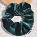 Close-up of dark green velvet scrunchie featuring a functional hidden zipper pocket - Lake Blue