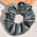 Close-up of velvet scrunchie featuring a hidden zipper pocket in silver grey - Gray