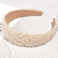 Detailed view of handmade pearl velvet headband with elegant white beads on luxury fabric - White