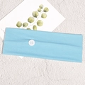 Detail of light blue knitted sports headband with a white button for mask relief - Sky Blue