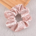 Close-up of pink velvet scrunchie showing pleated texture and soft fabric sheen - Pink