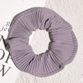 Detail view of purple pleated chiffon scrunchie with soft lilac fabric texture - Purple