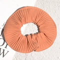 Detailed view of an orange pleated oversized hair scrunchie with vertical stripe texture - Orange