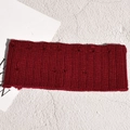 Detail of burgundy knitted headband featuring soft pom-pom textures and ribbed cotton fabric - Burgundy