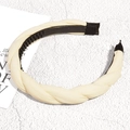 Detail view of the cream braided headband featuring a non-slip toothed inner grip - Off White