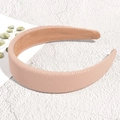 Detail view of light pink padded faux leather headband with textured surface and non-slip lining - Pink