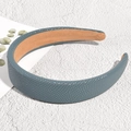 Detail view of navy blue leather headband with pebble texture and khaki fabric lining - Lake Blue
