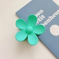 Detail of a mint green matte flower hair claw clip with a subtle frosted texture - Emerald