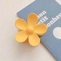 Matte yellow flower hair claw clip with floral design on blue decorative book - Leaf Yellow