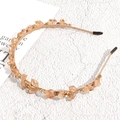 Detailed close-up of champagne crystal headband with elegant beads on a metallic frame - Champagne