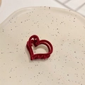 Macro detail of the deep red heart-shaped velvet flocking hair claw on a ceramic plate - Heart Shape / Red Heart