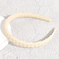 Detail shot of the cream checkered fabric texture and non-slip design on this headband - Thin White