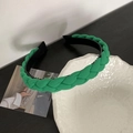 Close-up of green braided headband featuring a soft fabric texture and non-slip inner lining - Green