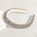 Detailed close-up of wide headband with dense silver and grey crystals in baroque style - Black