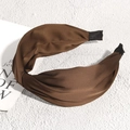 Detail showing the coffee brown satin cross knot headband with a smooth silk-like luster - Brown