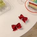 Close-up of small dark red fabric bow hair clips with textured fabric on a white background - Hair Bow / Red