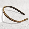 Detailed macro view of black crystal rhinestones set in golden claw chain on thin headband - Thin Rhinestone Black