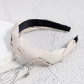 Close-up of beige braided headband with satin texture and black anti-slip lining - White