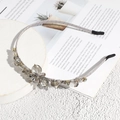 Close-up of elegant grey crystal beads and flower detail on a satin headband - Gray