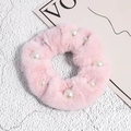 Detail of pink faux rabbit fur scrunchie with elegant pearls and fluffy texture - Pink