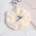 Close-up of soft beige faux fur scrunchie with white pearl accents and fluffy texture - Off White