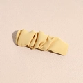 Detailed view of light yellow ruched fabric hair clip with elegant pleated texture - Light Yellow