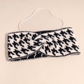 Detailed close-up of a knitted houndstooth headband with a stylish central twist design - Off White
