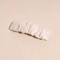 Detail of cream pleated fabric hair clip with elegant mesh texture and rectangular design - White