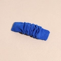 Detail of Klein blue ruched fabric hair clip with a minimalist textured fold design - Blue