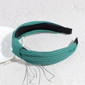 Detail of green ribbed knit fabric headband with a stylish knotted design and non-slip lining - Dark Green