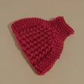 Detailed macro shot of red knitted headband showing thick textured crochet wool pattern - Red