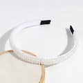 Detailed view of white faux pearl headband featuring triple row design and non-slip tips - Dense Pearl Style