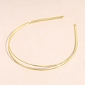 Detailed close-up of a minimalist golden double-line metal headband on a pink background - Double Row Gold