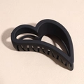Detail of matte black heart-shaped hair claw clip on textured background - Heart Style / Black