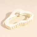Close-up of a wavy cream-colored hair claw clip with a visible metal spring - Cloud Style / White