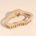 Detailed view of matte beige irregular wave hair claw clip with strong metal spring - Cloud Style / Brown
