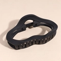 Macro shot of matte black wavy hair claw clip showing durable spring and anti-slip teeth - Cloud Style / Black