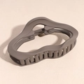 Detail of matte coffee brown hair claw clip with irregular wavy hollow design - Cloud Style / Brown