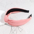 Pink ribbed knit knotted headband with stylish twist design and nonslip lining - Orange Pink