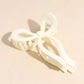 Detailed close-up of matte cream-colored butterfly hair claw clip with metal spring - Bow Style / White